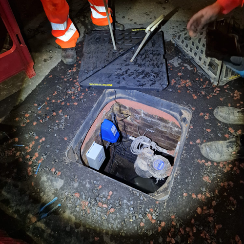 Manhole cover with communications antenna installed