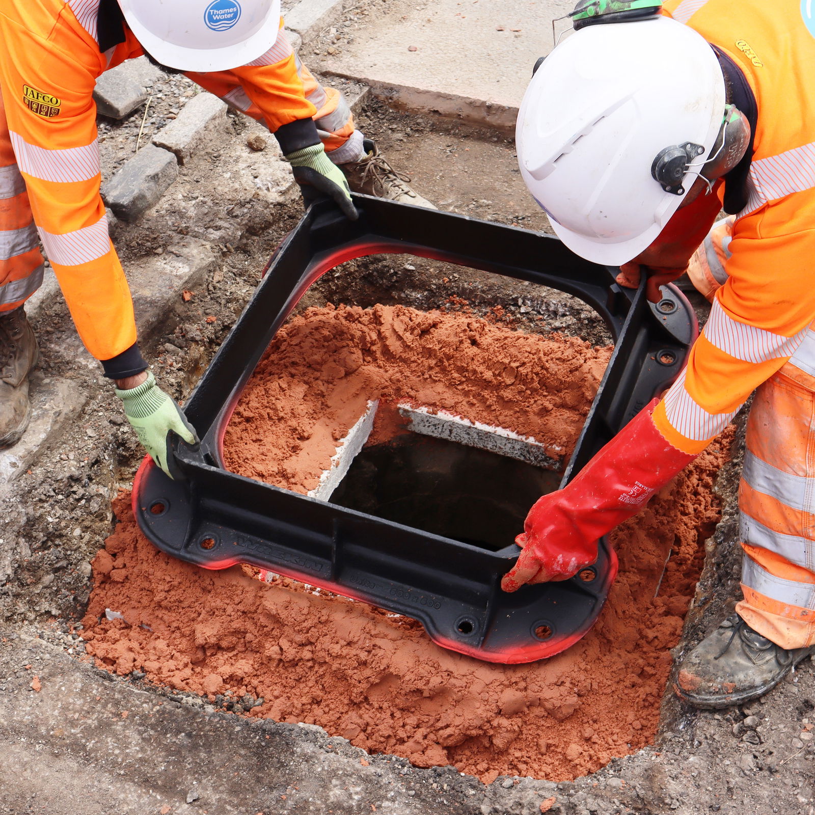 Operatives installing a Unite manhole cover frame