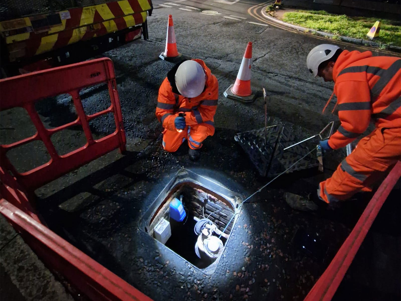 Ground workers inspecting Wrekin Unite manhole cover