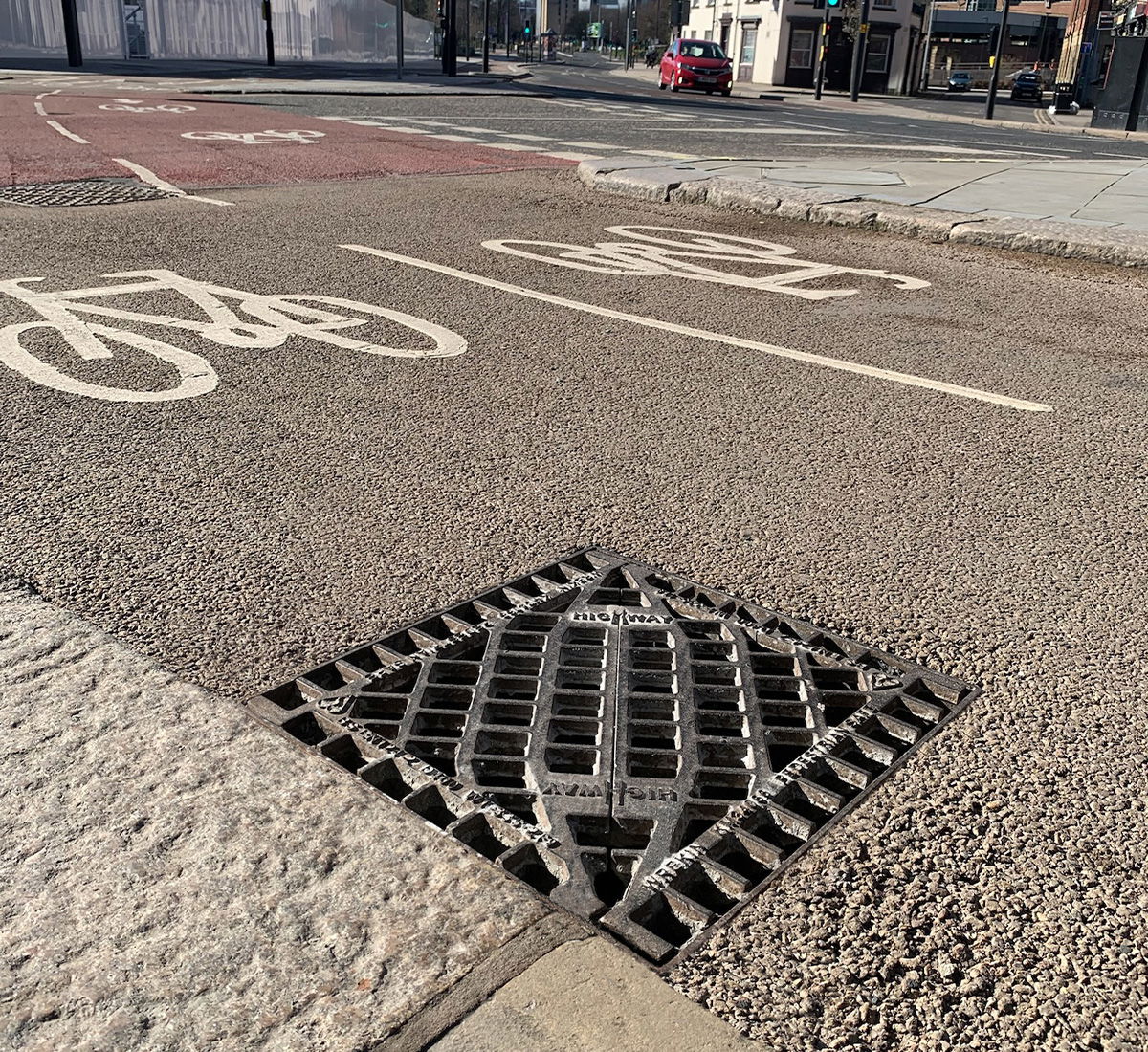 Pedestrian gully grate in a cycle lane
