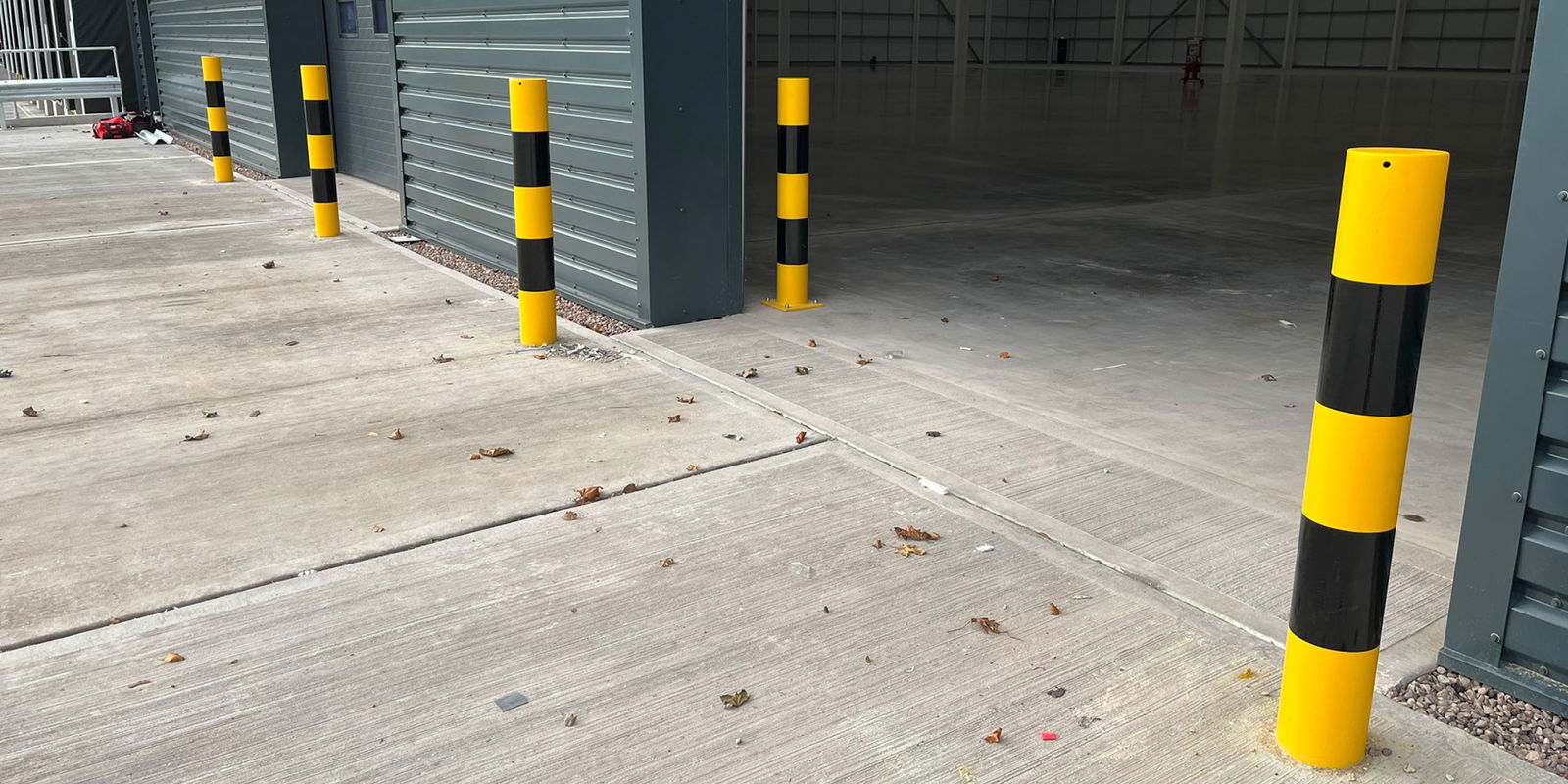 Bespoke painted steel bollards installed outside warehouse