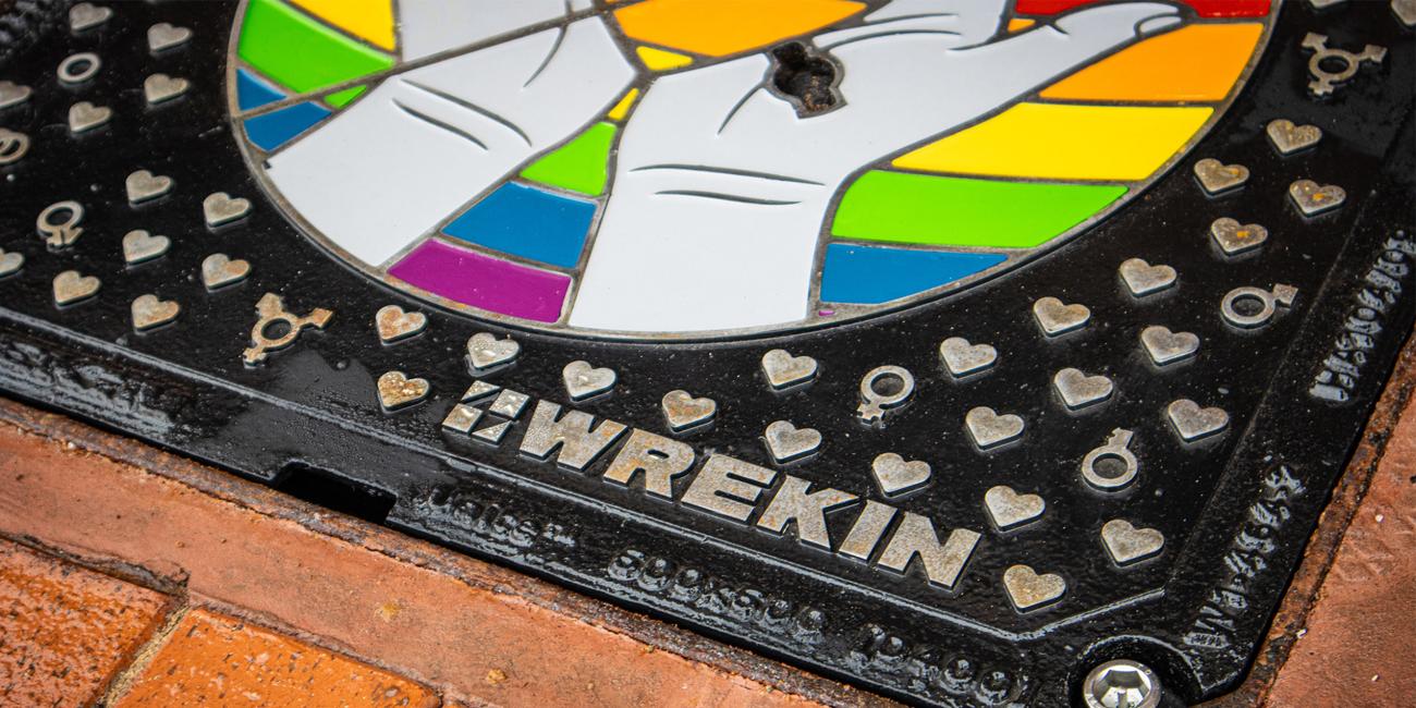 Wrekin bespoke LGBT manhole cover in block paved area