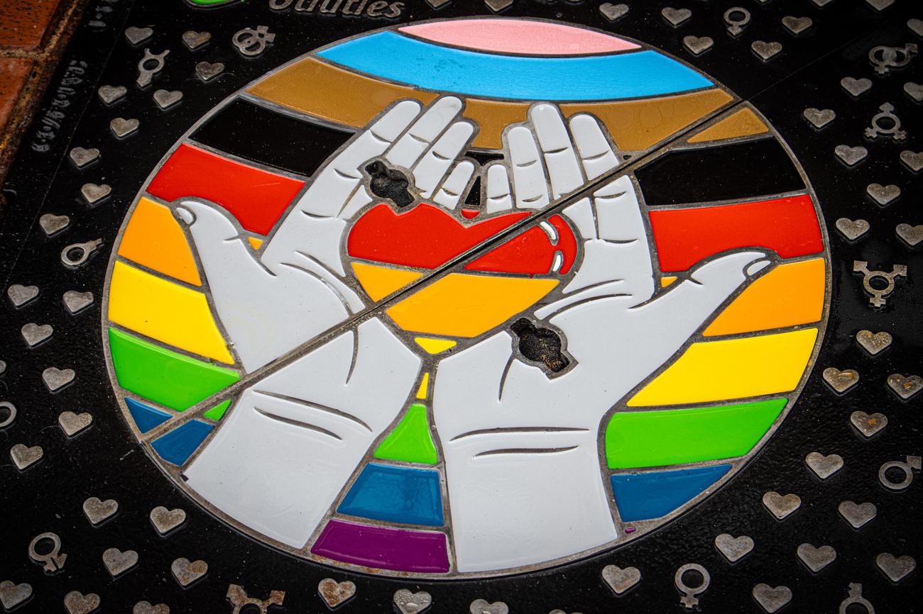 A heart held in hands as a chequer pattern on a bespoke Wrekin manhole cover