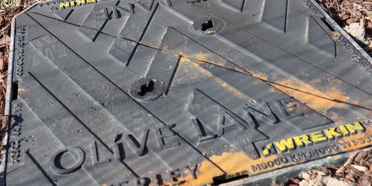Close up image of bespoke manhole cover at Olive Lane
