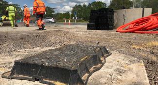 Unite manhole cover being installed