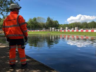 Construction worker looks out over water