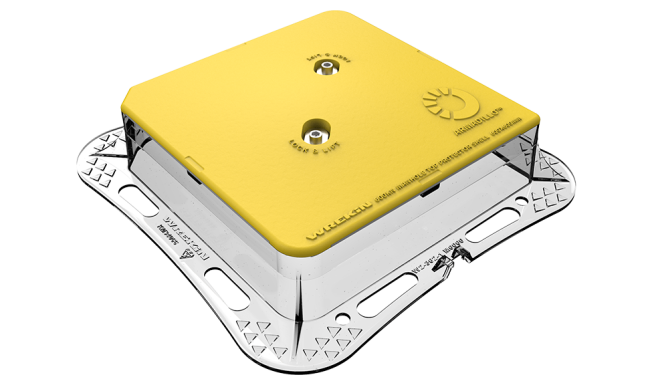 Armadillo manhole cover protector shell on top of a manhole cover