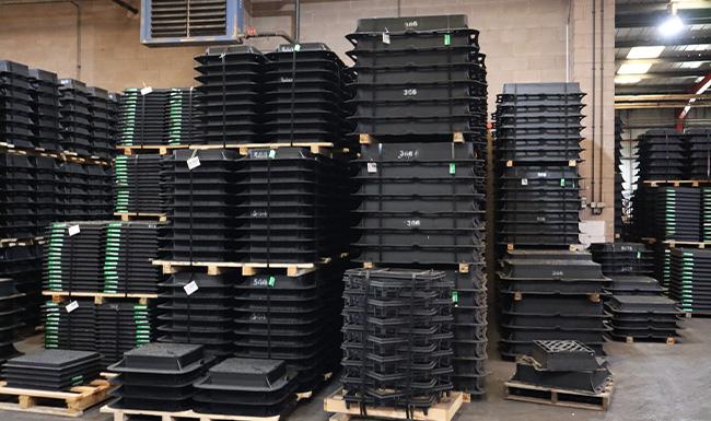 Manhole covers stacked in warehouse